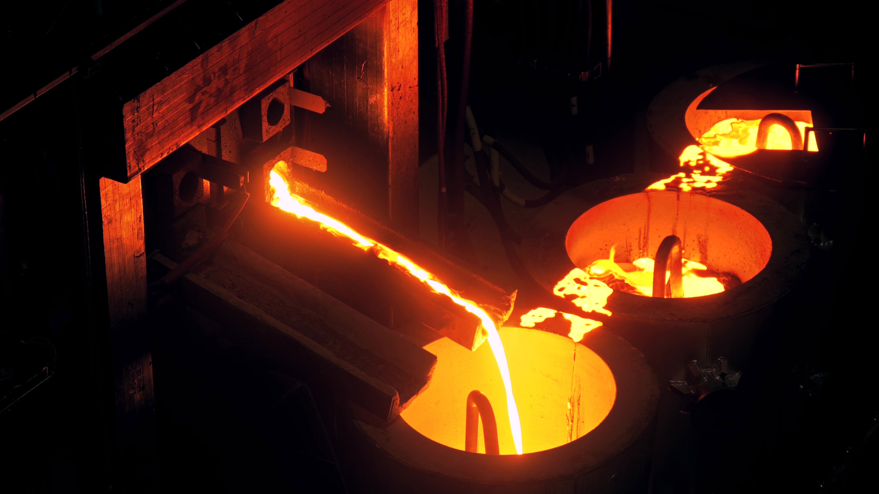 molten metal pouring down a chute into containers