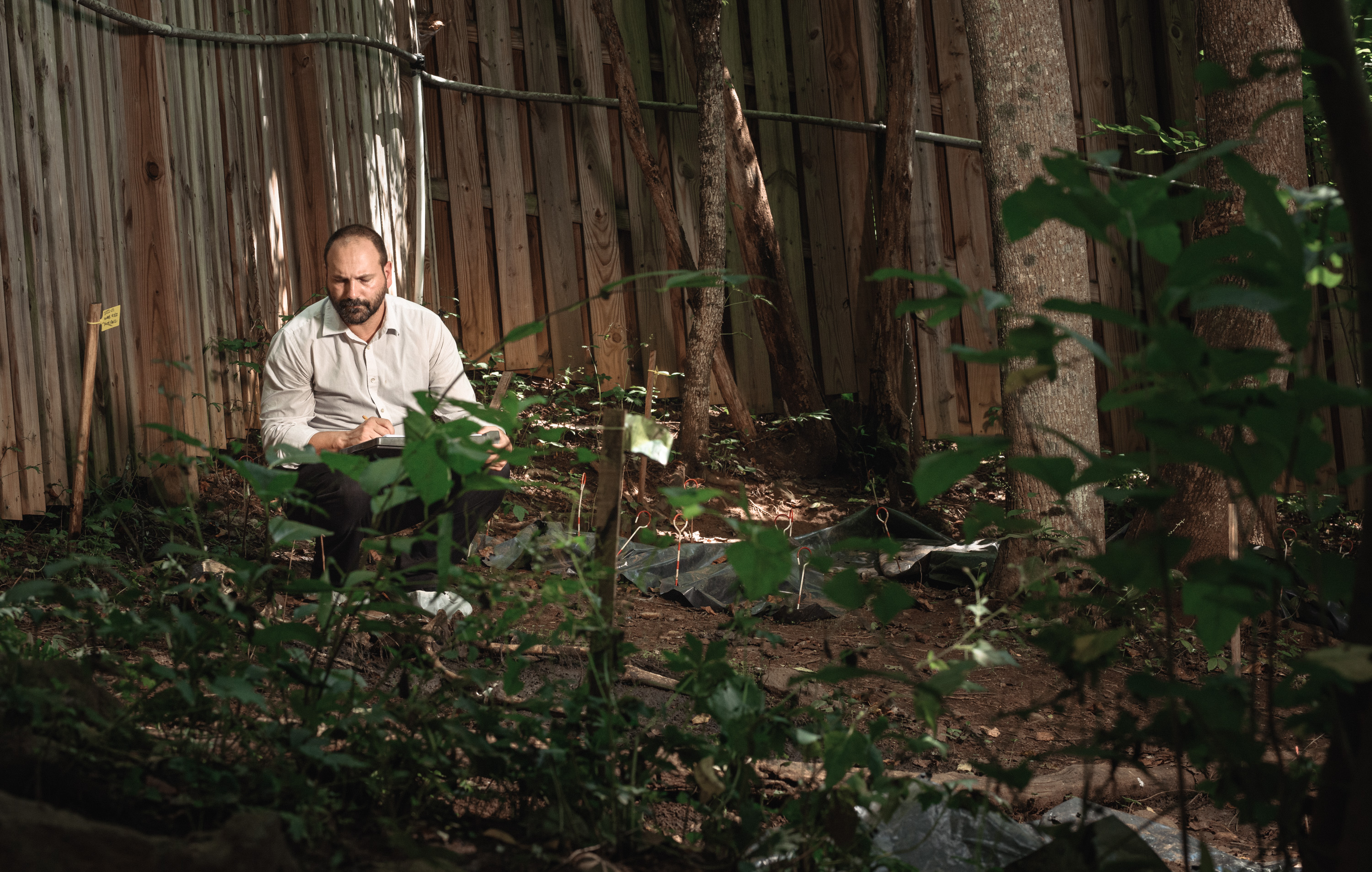 Dr. Nicholas Passalacqua, Forensic Anthropology Facilities Director at Western Carolina University observes a body at the decomp facility.